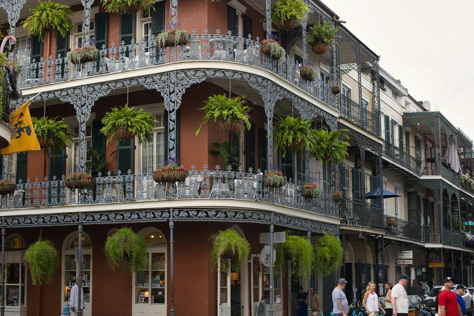 Beautiful wrought iron balconies and lush greenery in New Orleans' French Quarter.