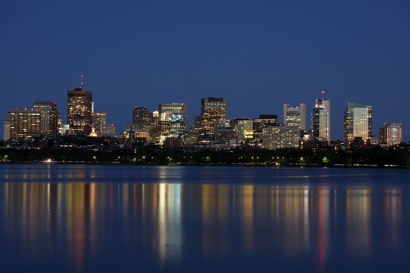 The Boston skyline rising over the harbor at dusk