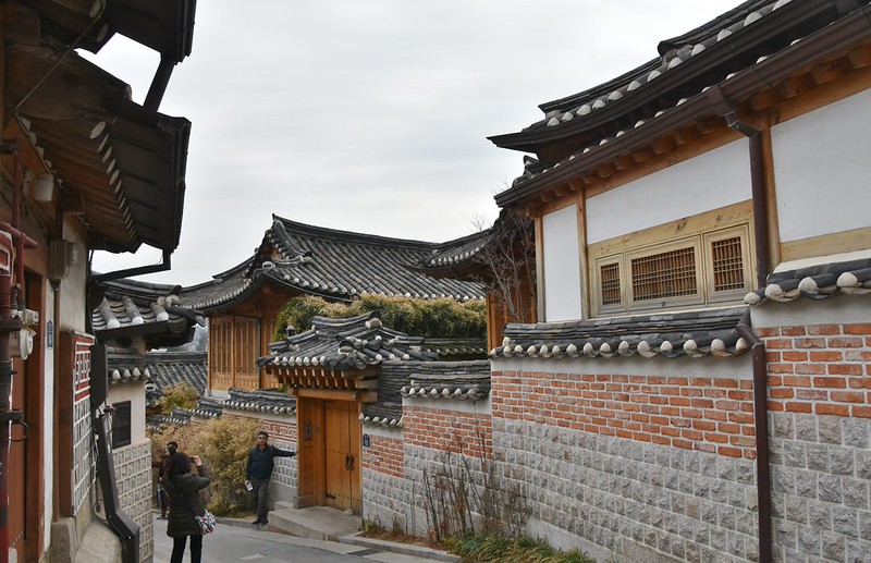 Traditional hanok rooftops lining a lane in Bukchon Hanok Village Seoul