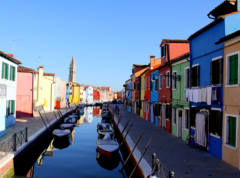 Brightly painted houses along a canal on Burano island near Venice