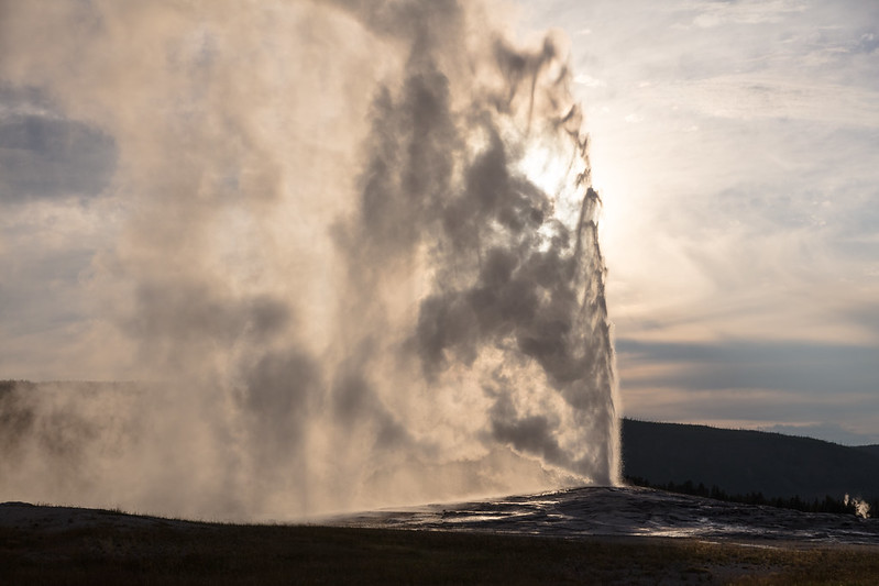 Old Faithful geyser erupting against the sky in Yellowstone