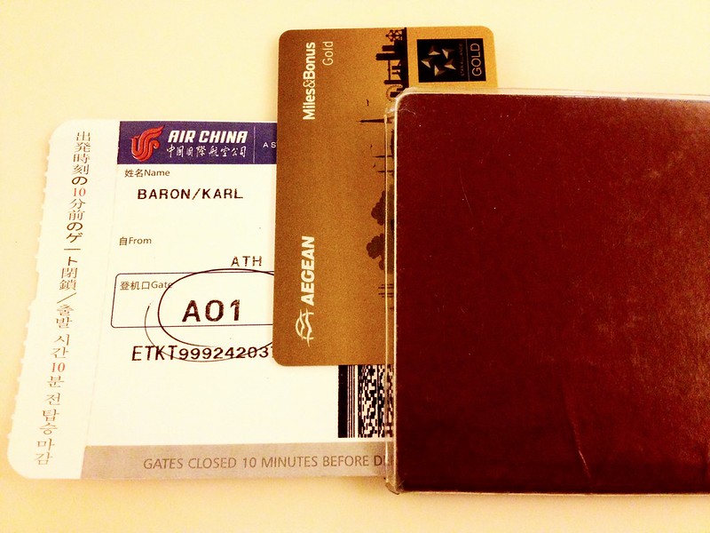 Passport, boarding pass and card laid out for international travel