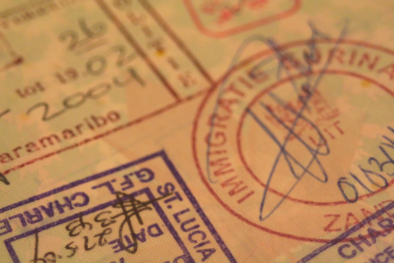 Passport pages filled with international entry stamps from world travel