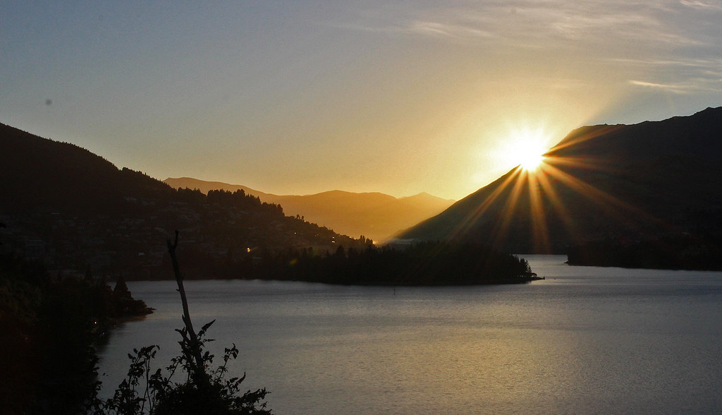 Dramatic sunrise over Queenstown New Zealand with lake and mountain views