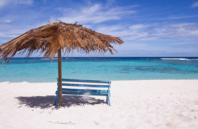 Retired couple relaxing on a tropical beach during a trip
