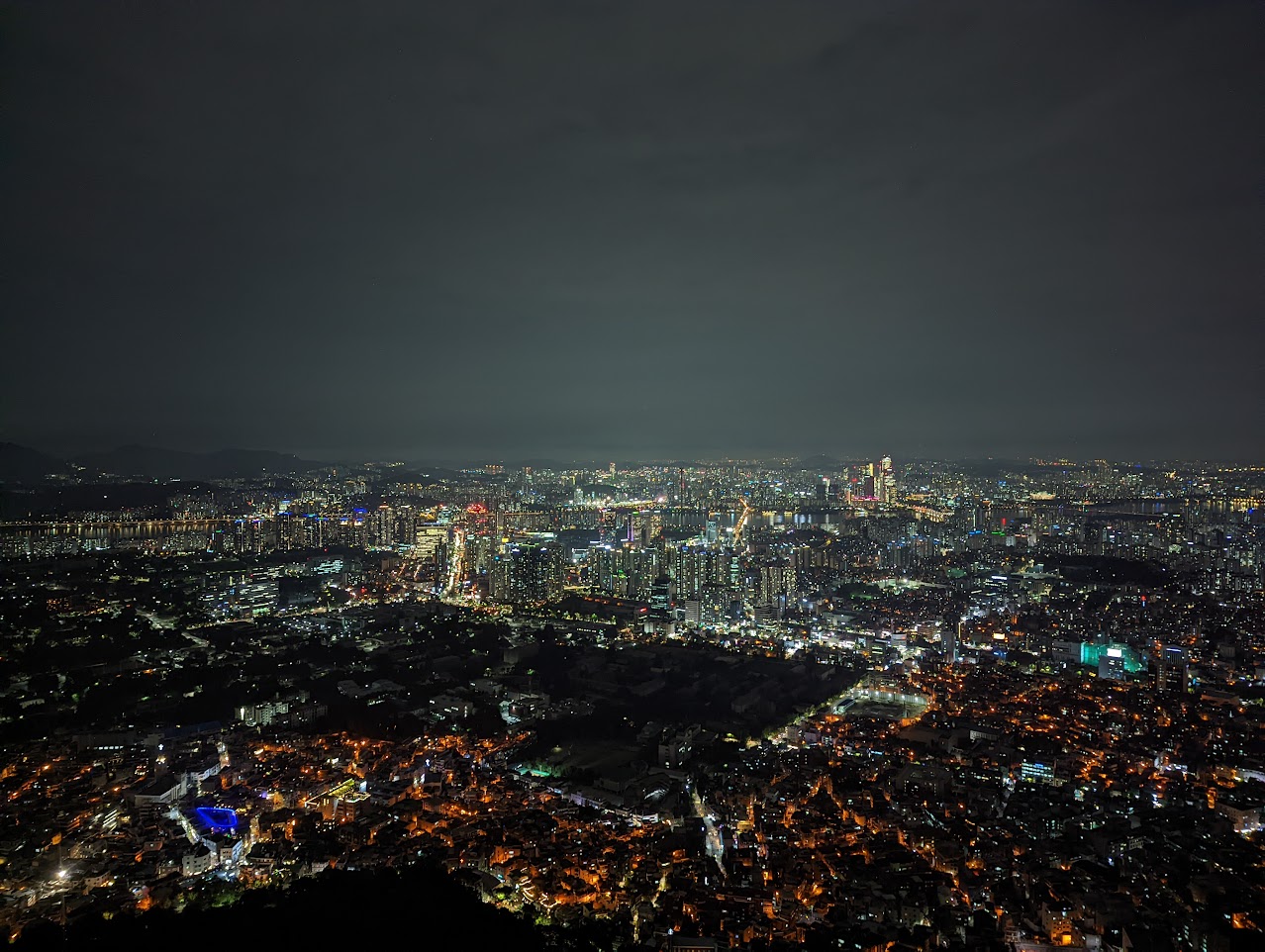 Seoul city skyline glowing at night with N Seoul Tower on Namsan