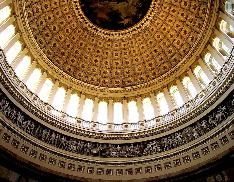 The United States Capitol Building dome against a blue sky in Washington DC