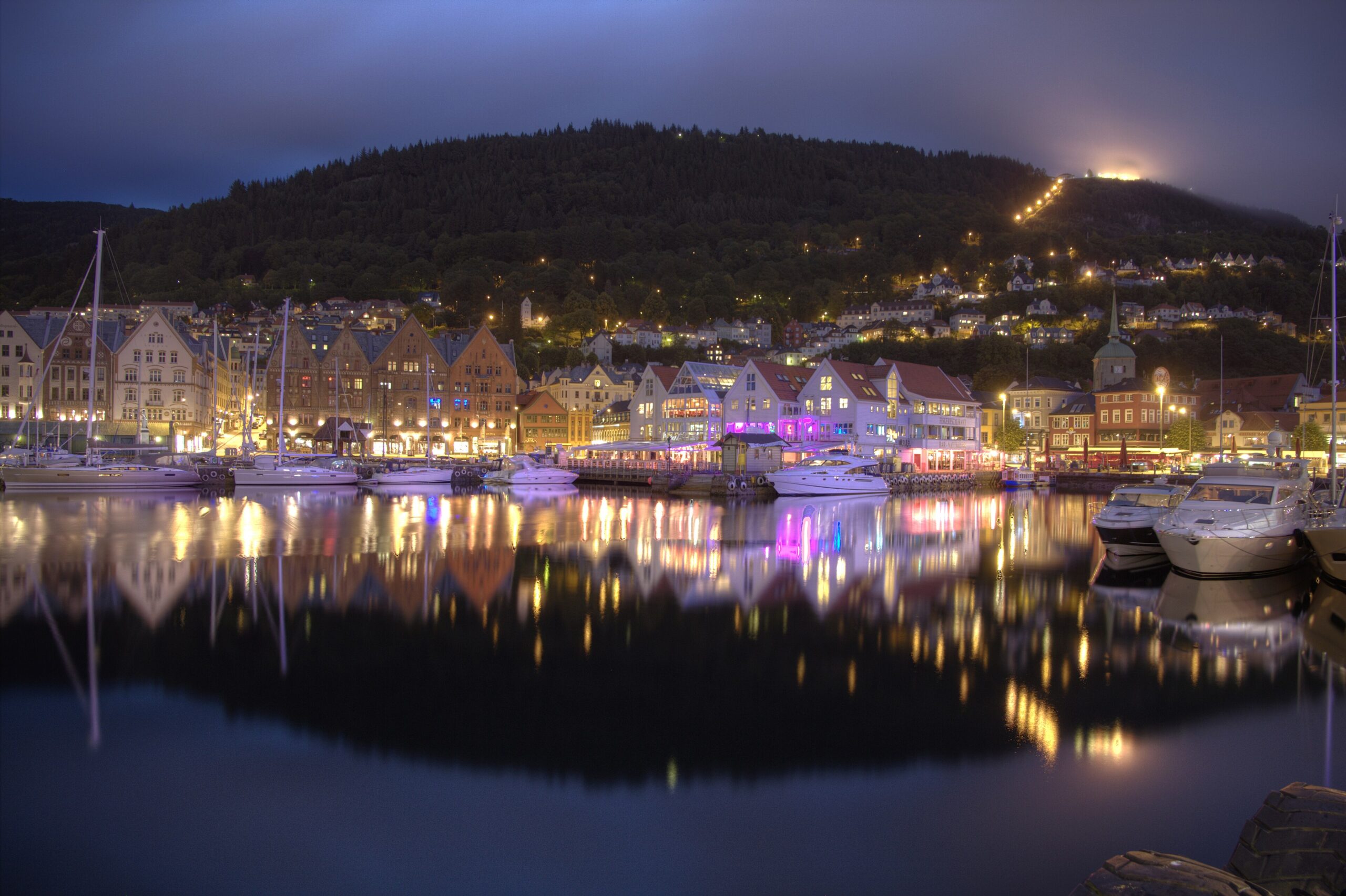 Bergen harbor and old wharf lit up and reflected on the water at night