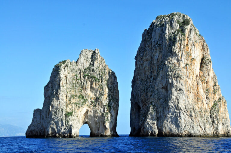 The Faraglioni sea stacks rising from bright blue water off Capri, Italy