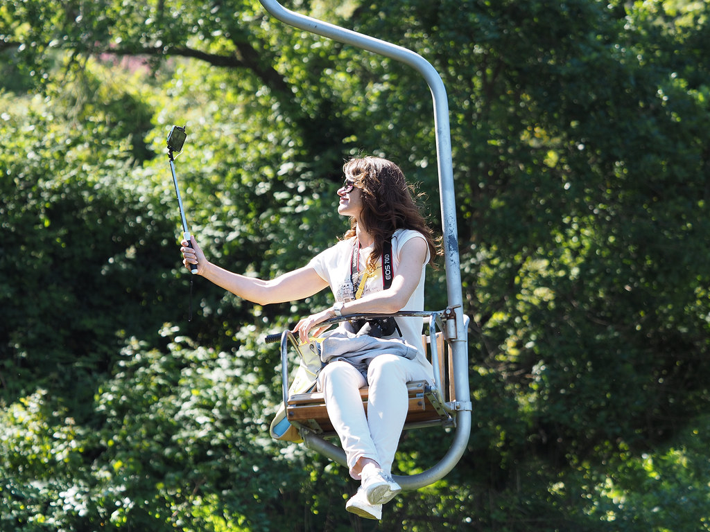 Rider on the single-seat chairlift climbing Monte Solaro above Anacapri, Capri