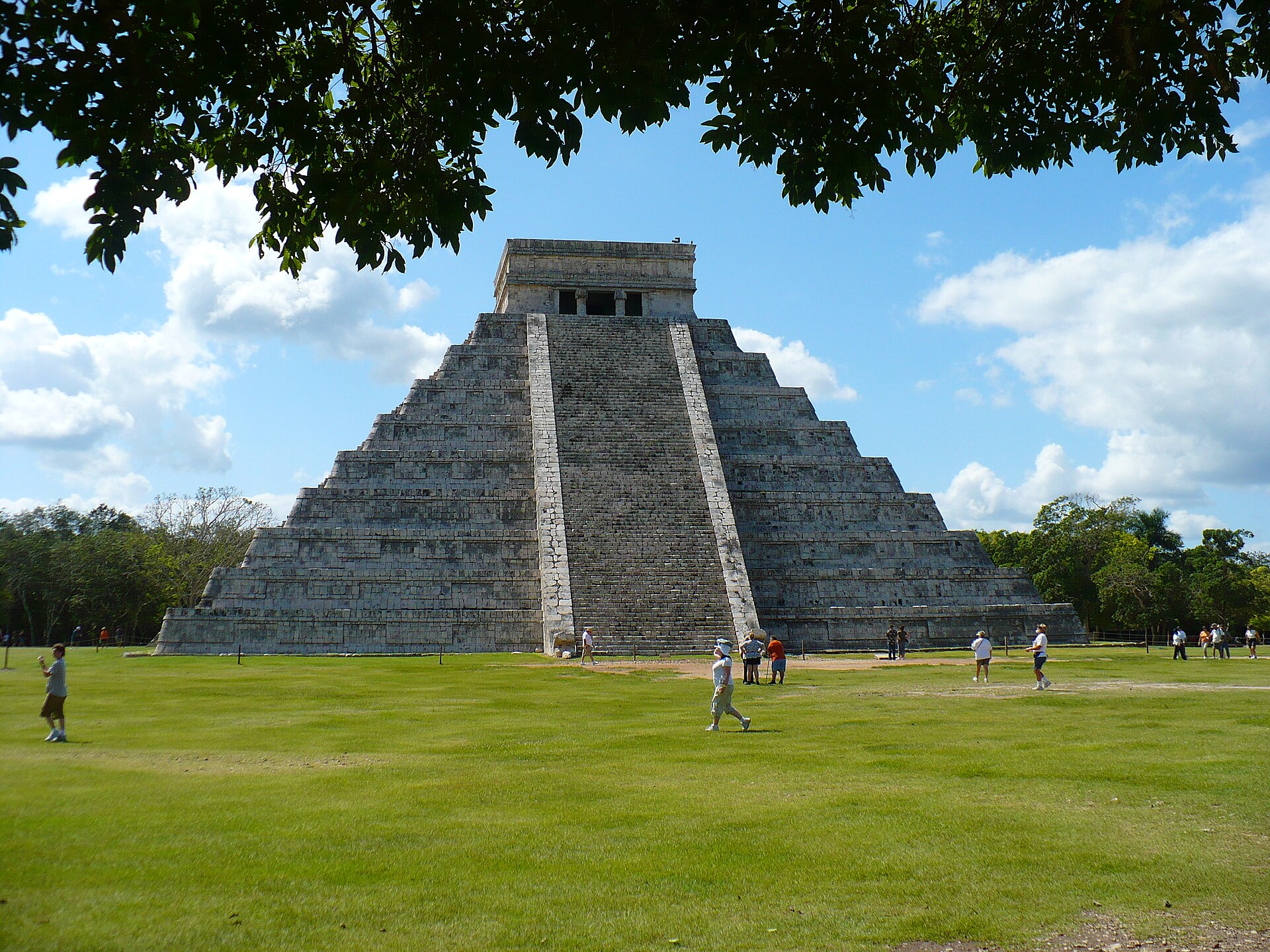 The Pyramid of Kukulkan at Chichen Itza against a blue sky in Mexico
