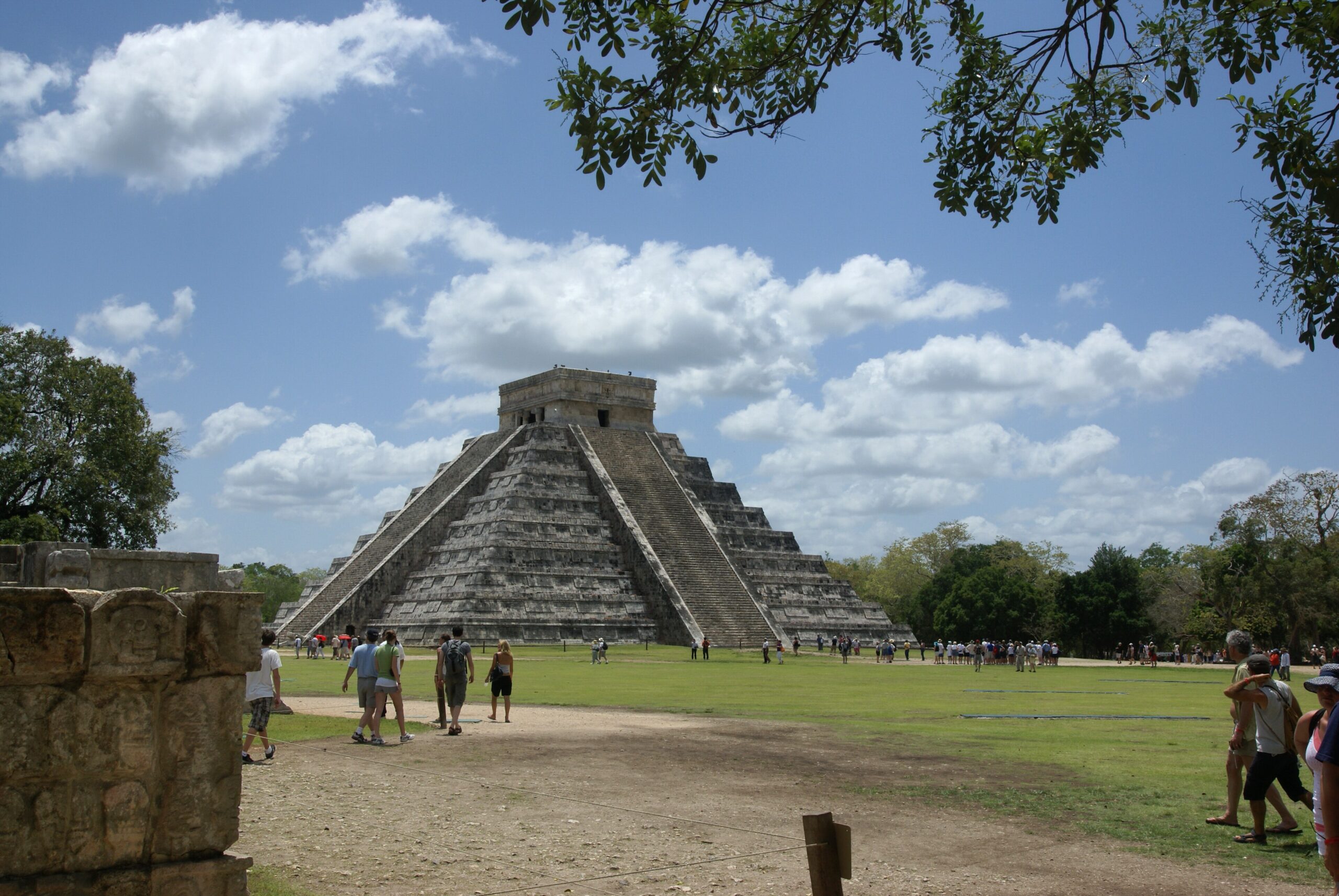 The Temple of Kukulcan pyramid at Chichen Itza under a blue sky in Mexico