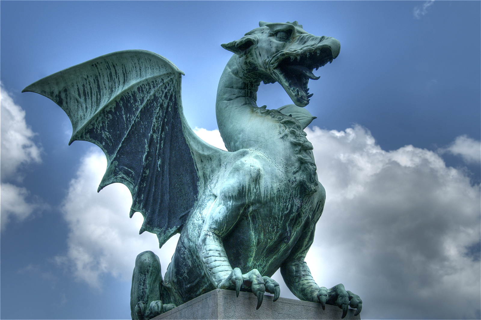 The famous copper dragon statue guarding the Dragon Bridge in Ljubljana