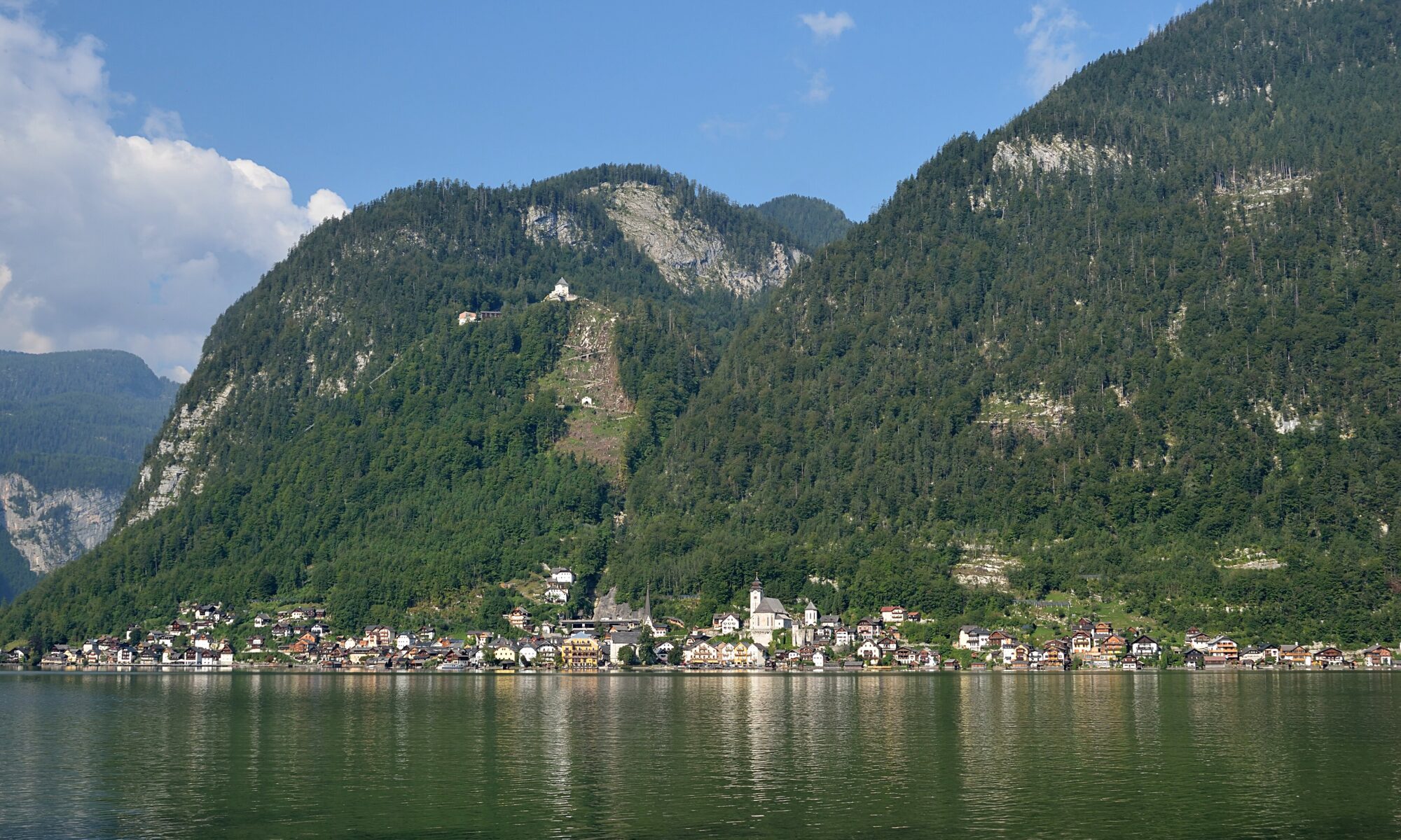 The village of Hallstatt mirrored in Lake Hallstatt beneath the Dachstein mountains