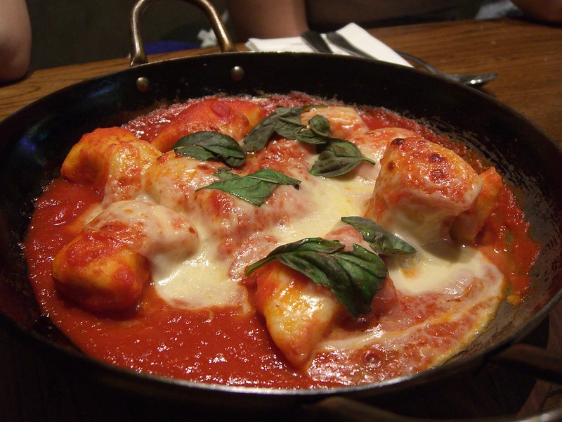 Baked gnocchi with tomato, basil, and mozzarella, an affordable Italian dish