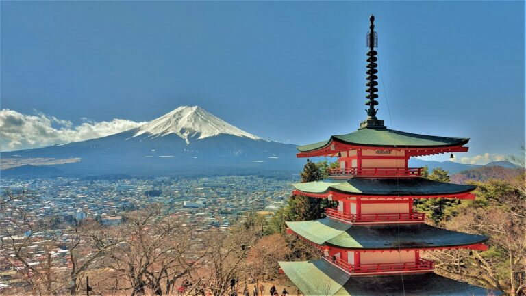 Mount Fuji behind the red Chureito Pagoda with cherry blossoms in Japan