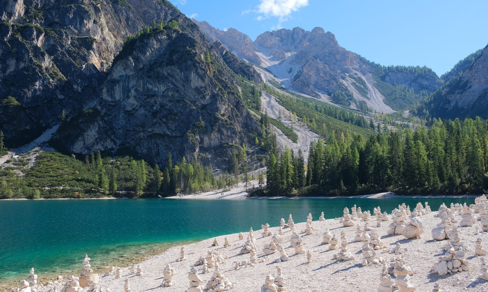 Turquoise water of Lago di Braies below the pale peaks of the Dolomites in South Tyrol, Italy