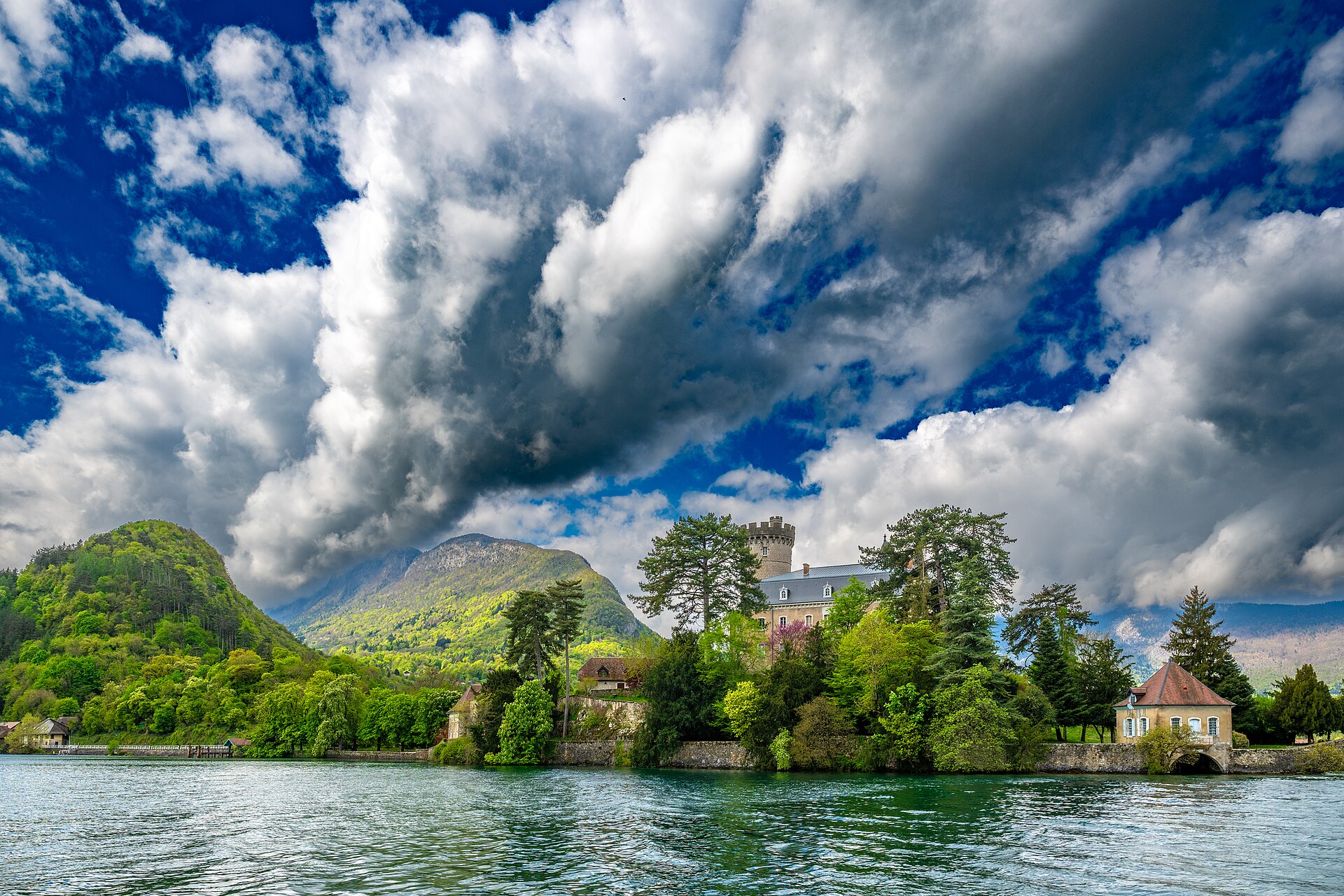 The clear turquoise water of Lake Annecy ringed by the French Alps
