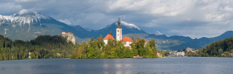 Bled Island and its church on Lake Bled below the clifftop Bled Castle in Slovenia