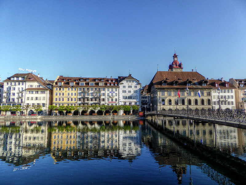 Colorful old town buildings reflected in the Reuss River in Lucerne