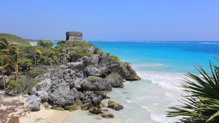 The Tulum Mayan ruins on a cliff above the turquoise Caribbean Sea in Mexico