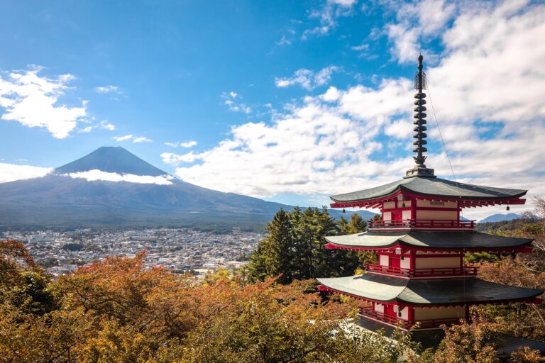 Mount Fuji rising behind the red Chureito Pagoda with autumn colors in Japan