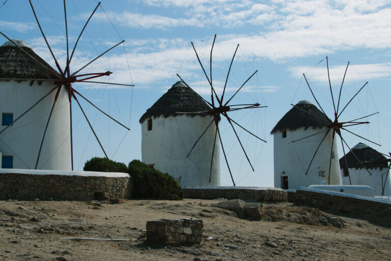 The iconic row of whitewashed windmills above Mykonos, Greece