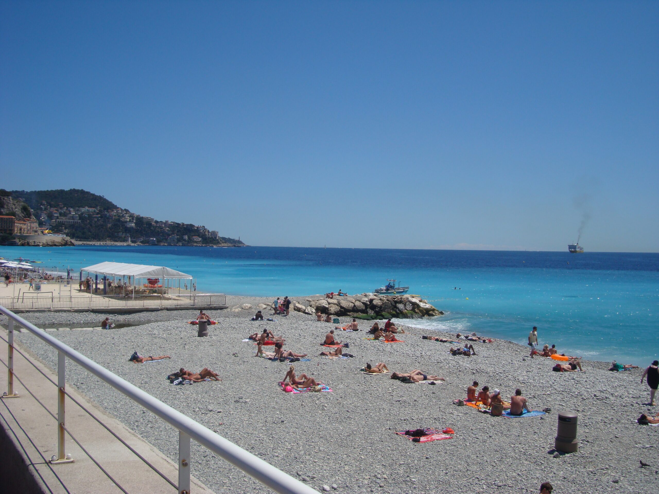 Pebble beach and clear blue Mediterranean water on the Baie des Anges in Nice France