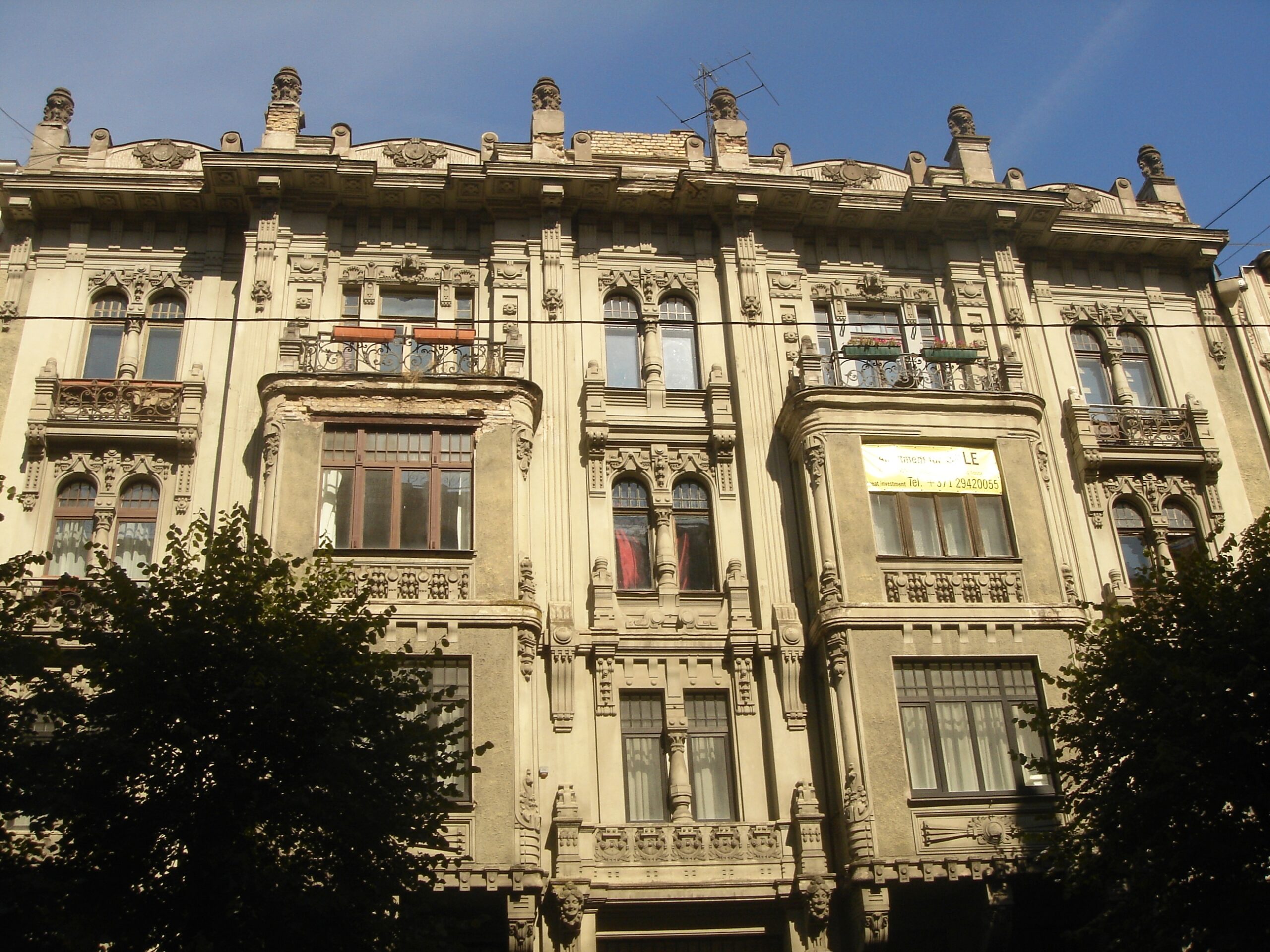 Ornate Art Nouveau facades with sculpted figures on Alberta Street in Riga