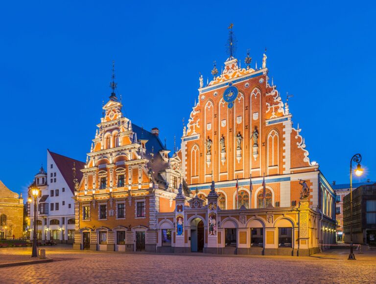 The ornate House of the Blackheads lit up at dusk in Riga old town Latvia