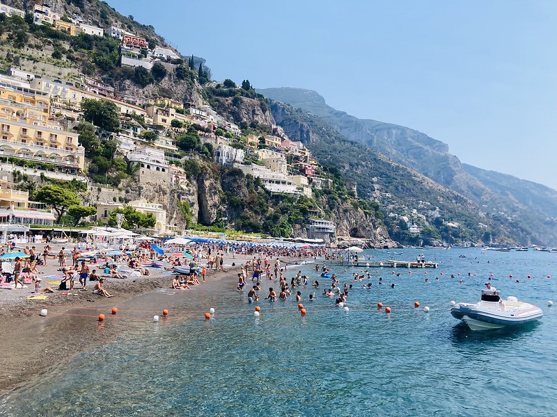 Sunbathers and colorful houses above Spiaggia Grande beach in Positano