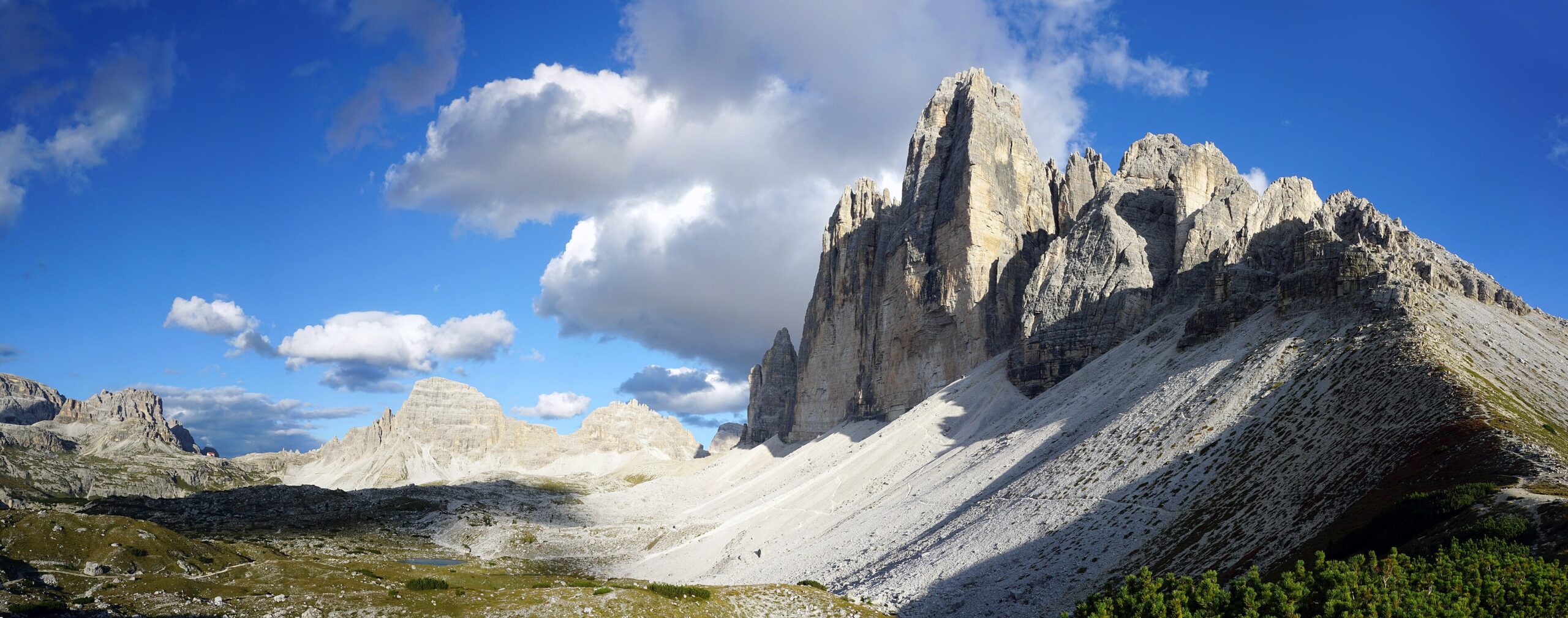 The three towering peaks of Tre Cime di Lavaredo against a blue sky in the Italian Dolomites