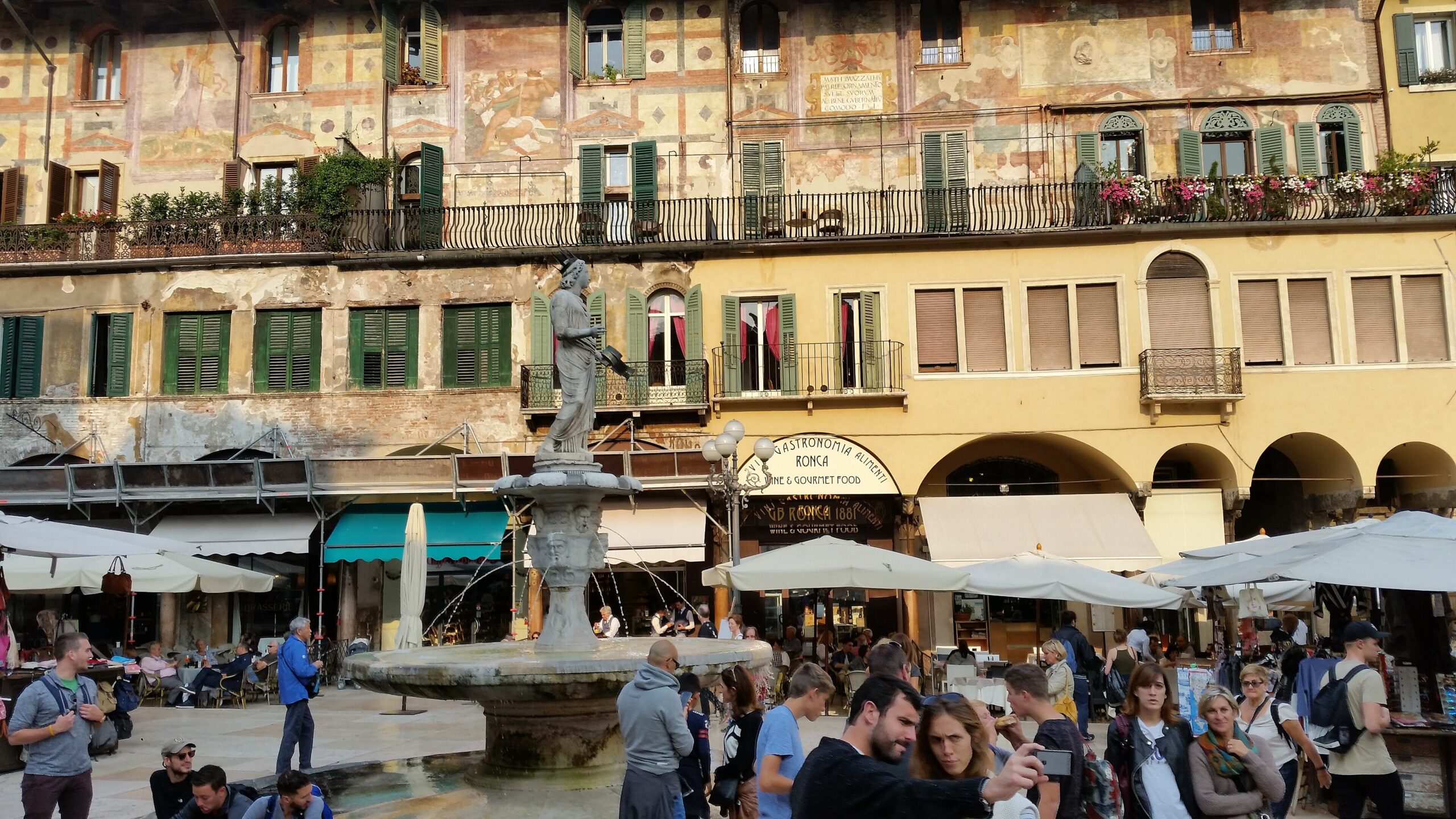 The frescoed buildings and market of Piazza delle Erbe in Verona Italy