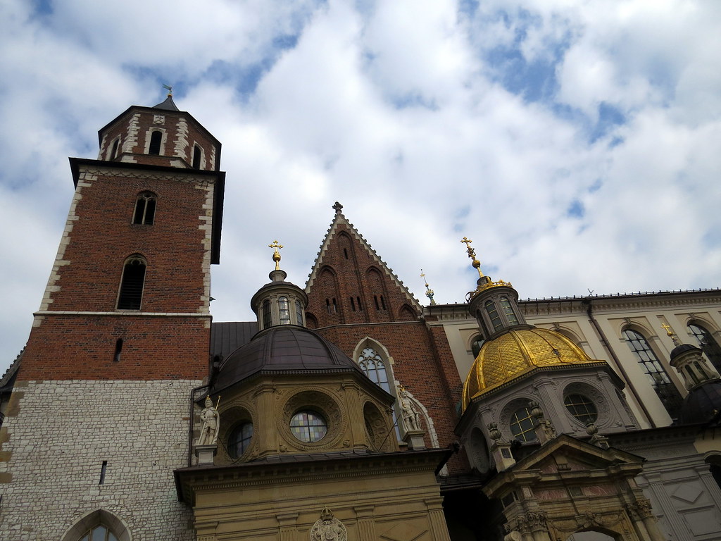 Towers and domes of Wawel Cathedral under a blue sky in Krakow