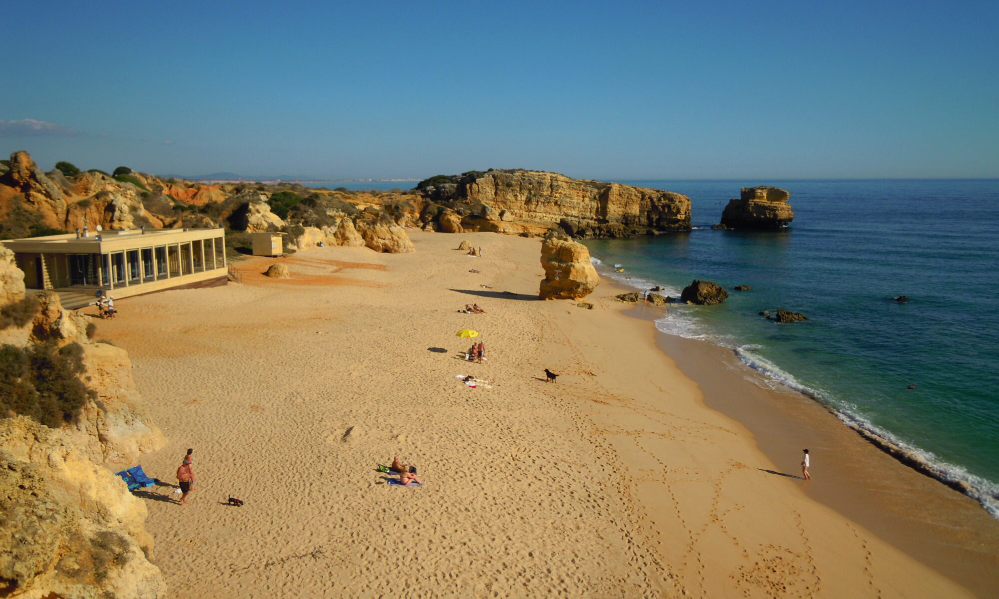 Golden limestone cliffs above a sandy cove on the Algarve coast in Portugal