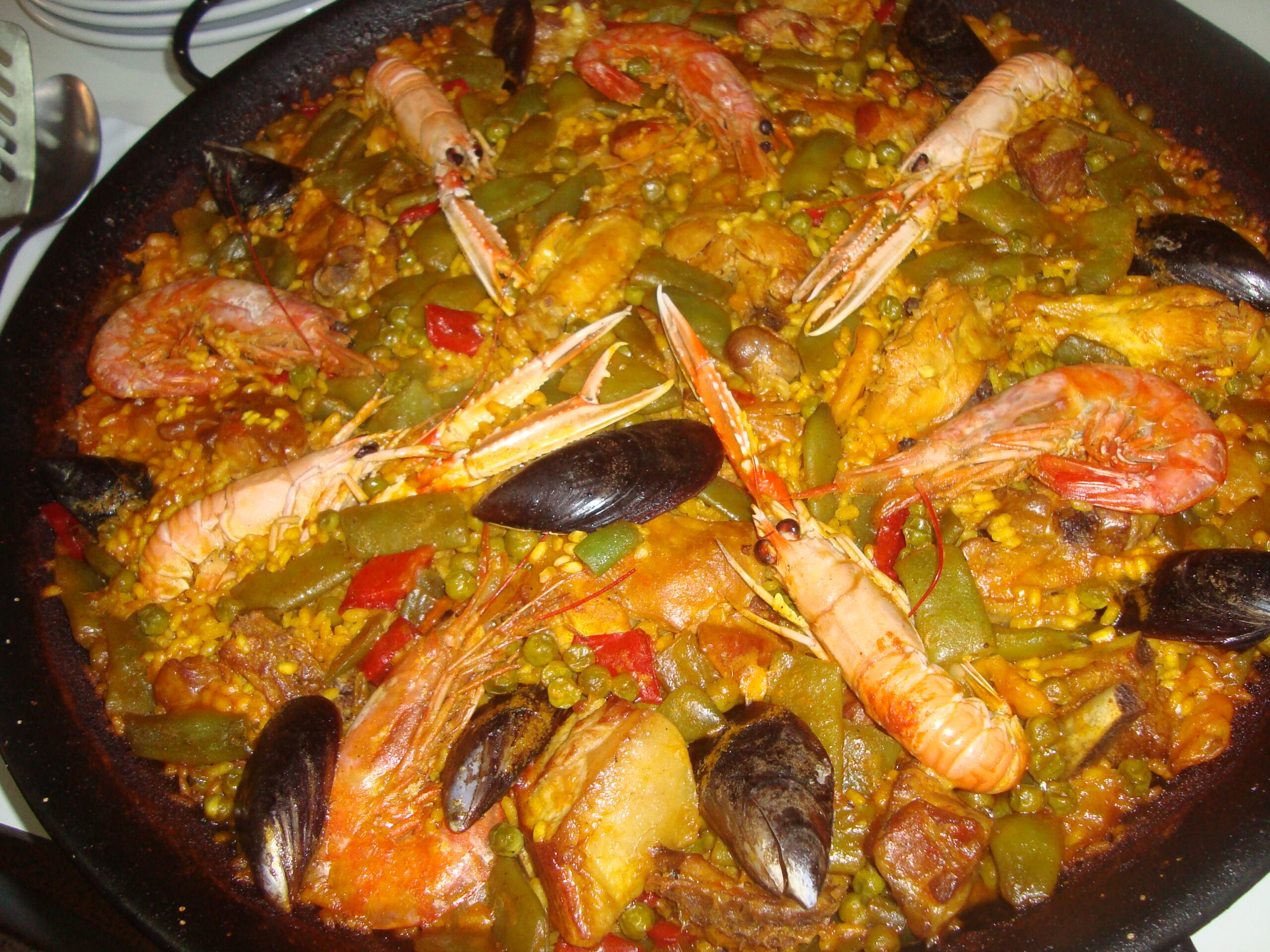 Traditional paella valenciana cooked in a wide pan in Valencia Spain
