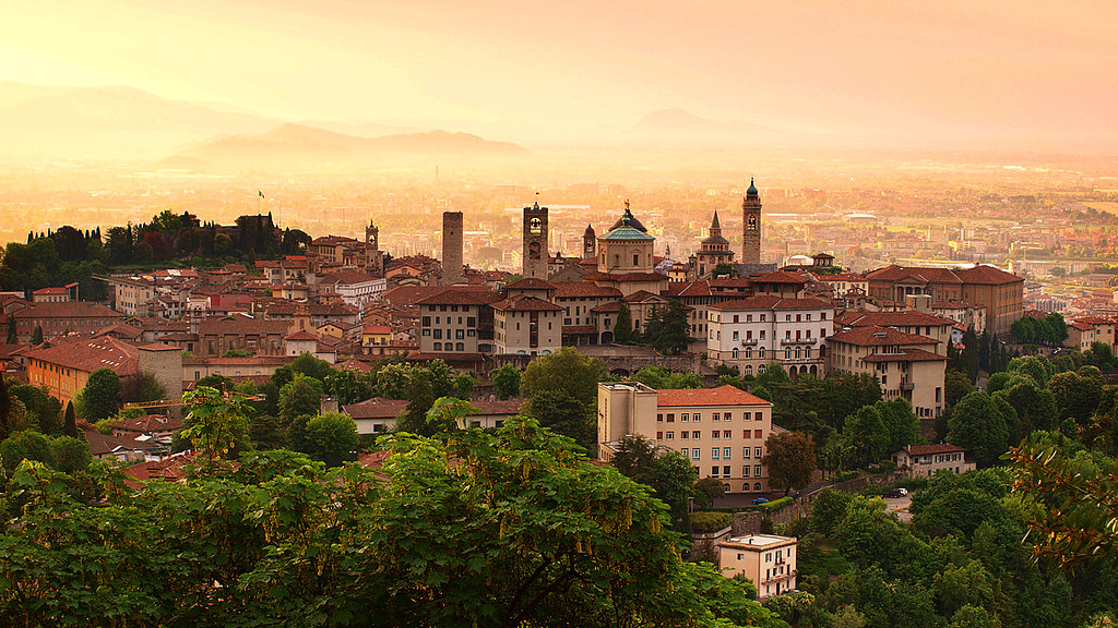 Sunrise light over the towers and domes of Bergamo's Citta Alta in Lombardy Italy