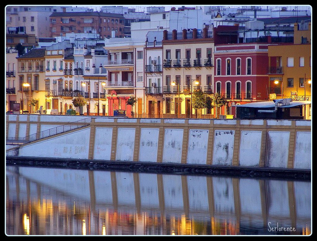 Colorful houses of Calle Betis in Triana at sunrise along the Guadalquivir river