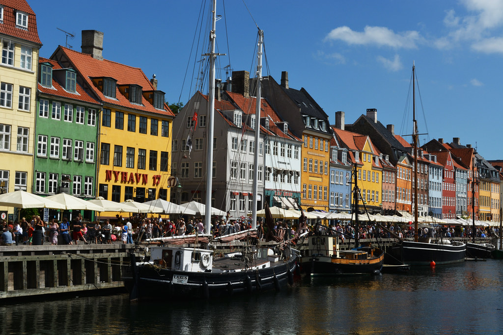 Canal boat passing historic Danish architecture in Copenhagen