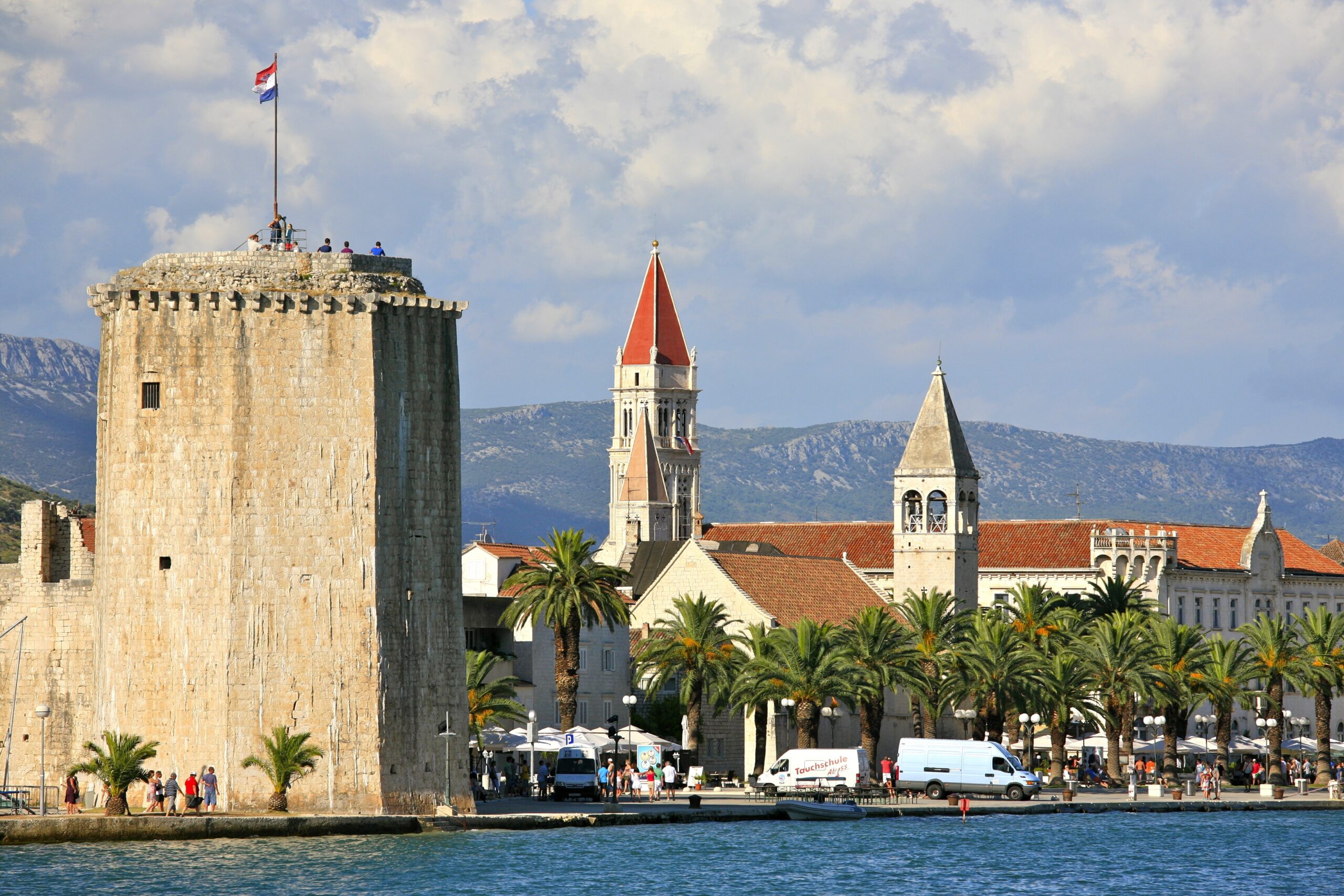 Aerial view of a walled Dalmatian coastal town and its harbour on the Croatian coast