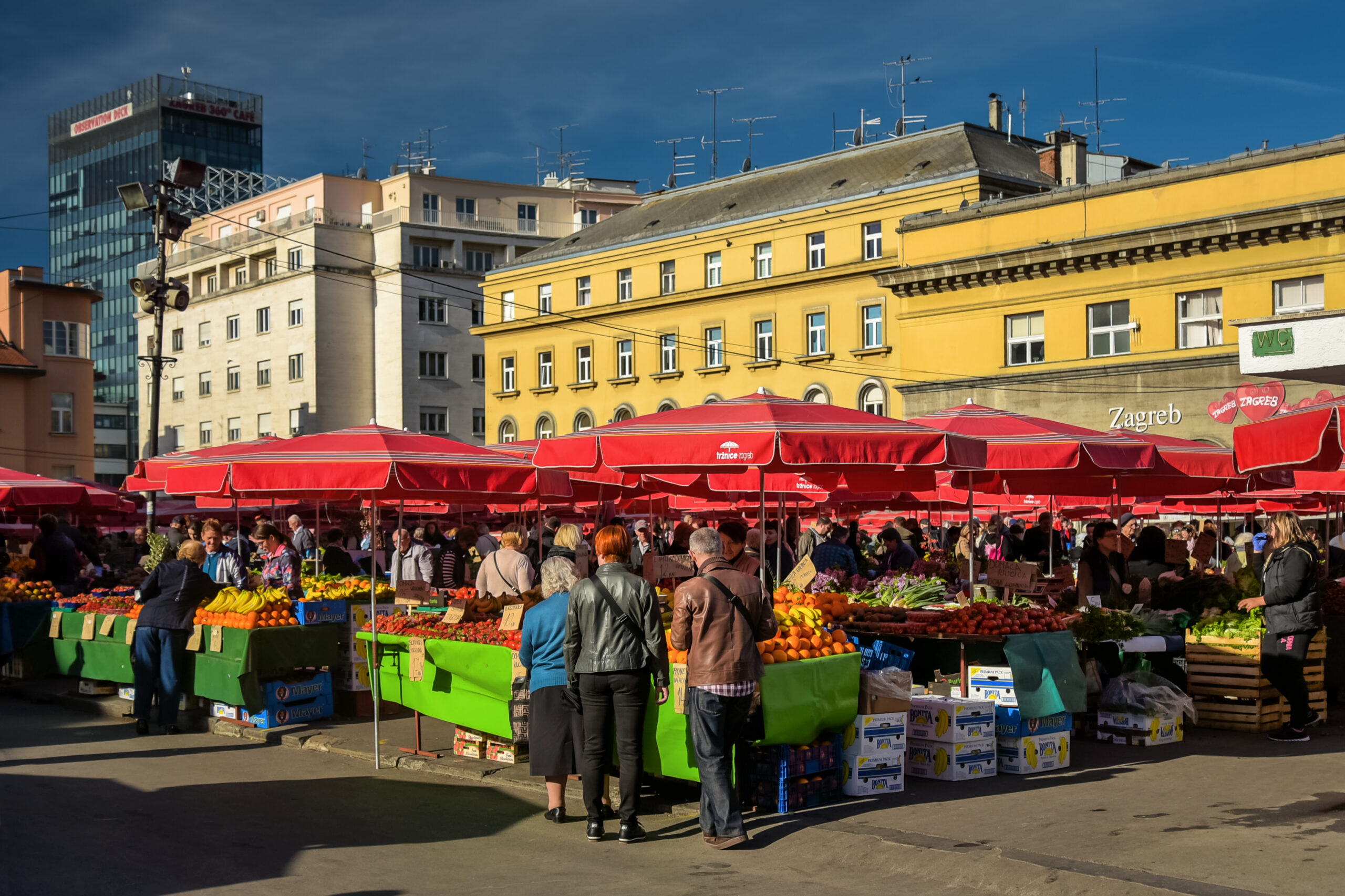 Rows of red parasols over the open air produce stalls at Dolac Market in Zagreb