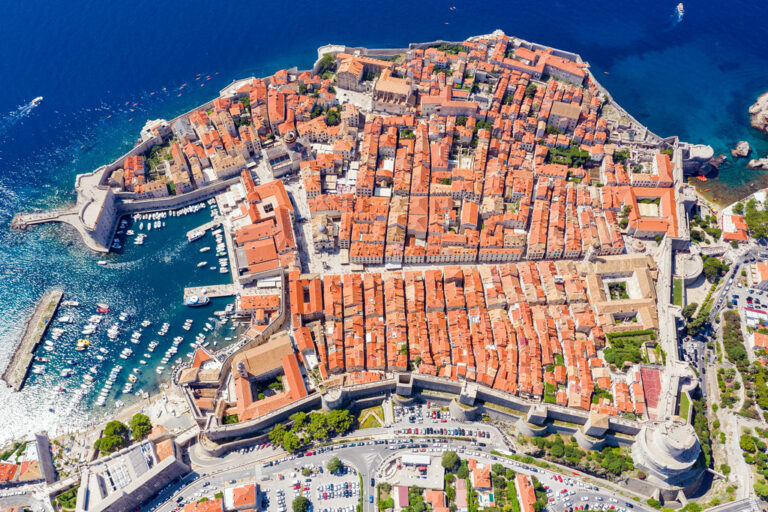 Aerial view of Dubrovnik's iconic city walls and the Old Town perched above the Adriatic Sea, Croatia