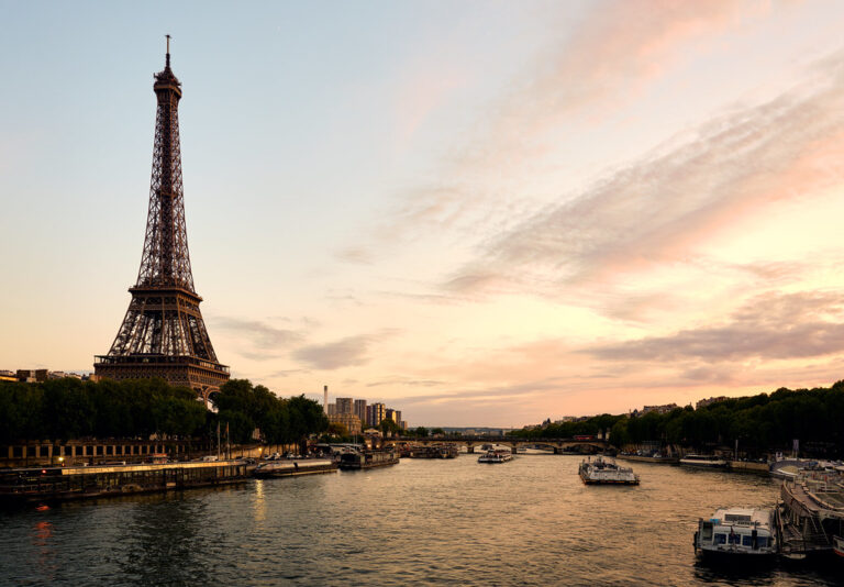 The Eiffel Tower rising over Paris on a bright colorful evening