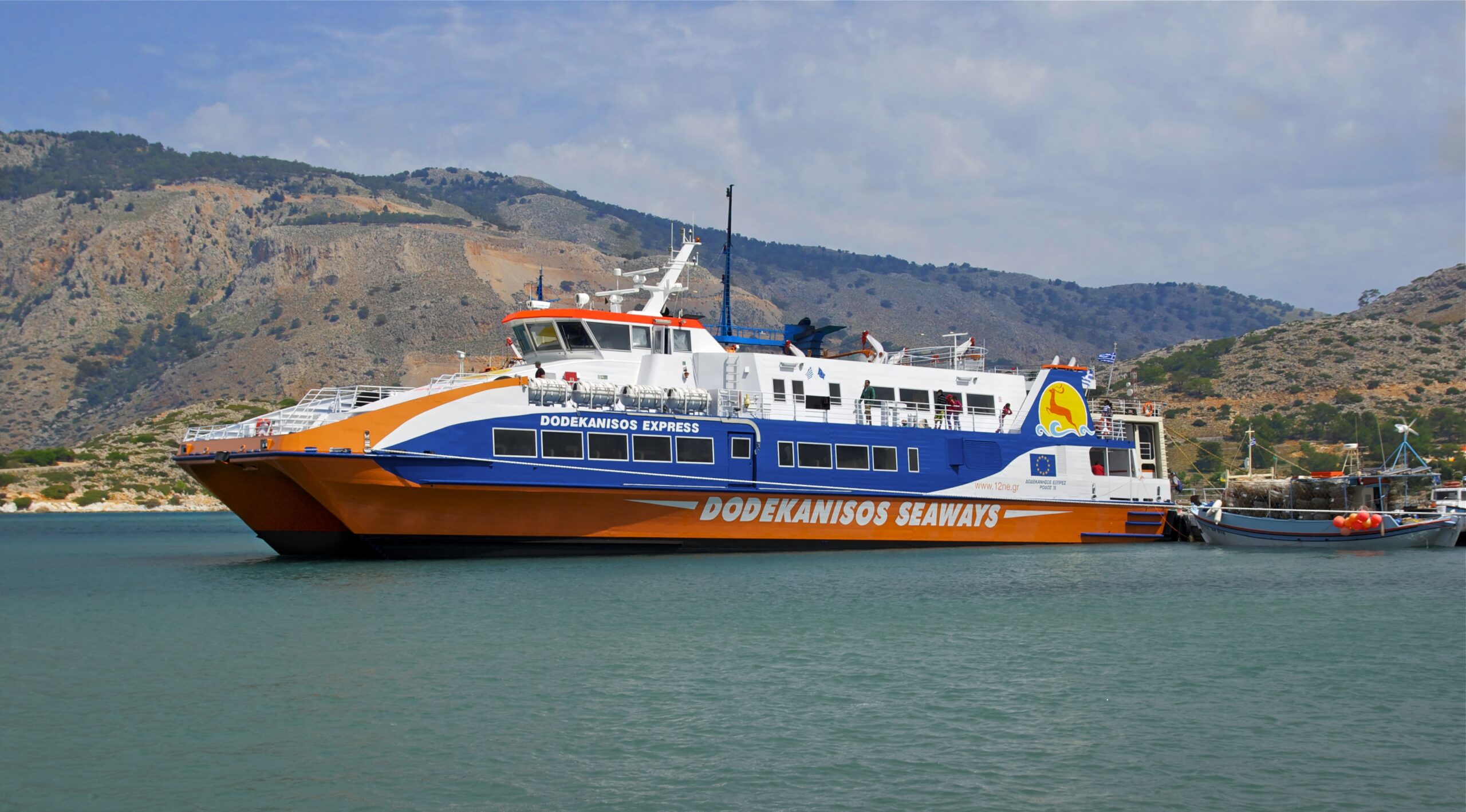 A Dodekanisos Express ferry docked at a Greek island harbour