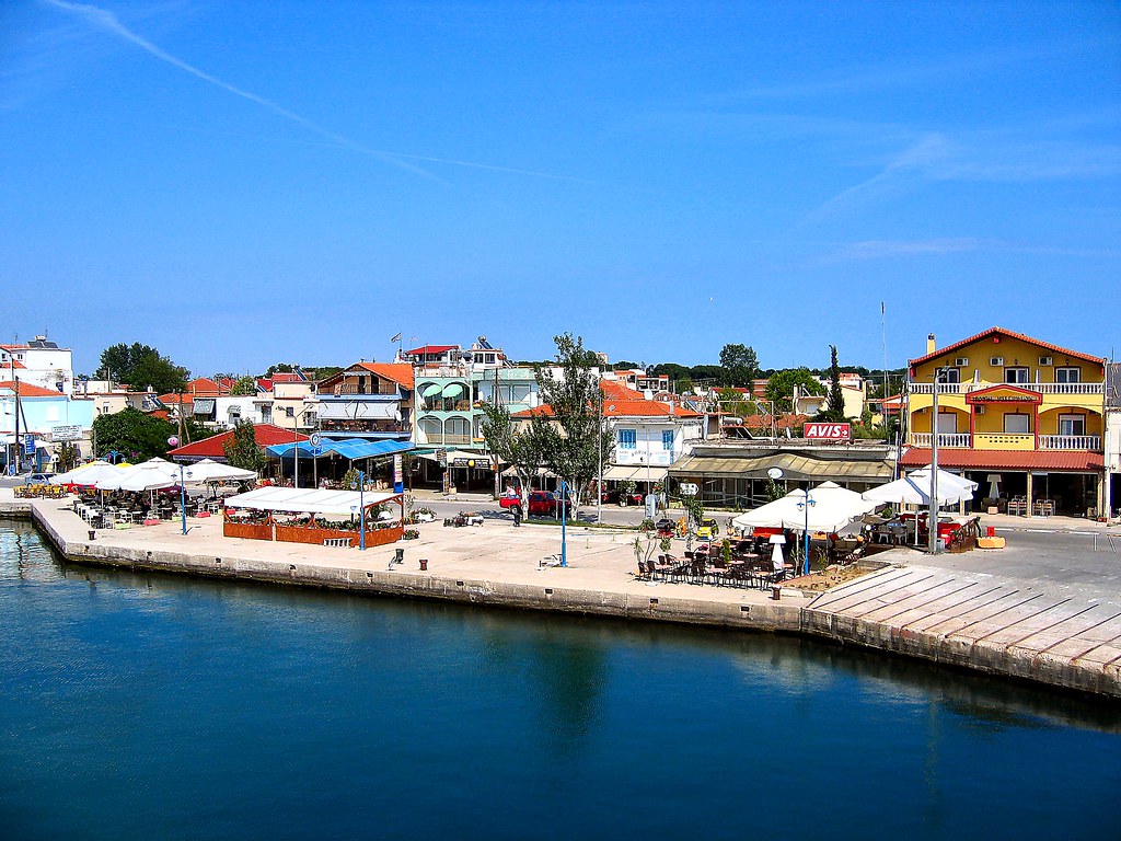 Boats moored along a quiet harbour front in Greece