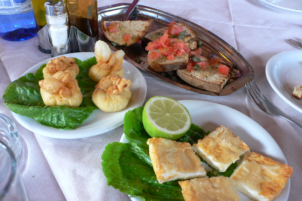 Plates of Greek meze laid out on a taverna table