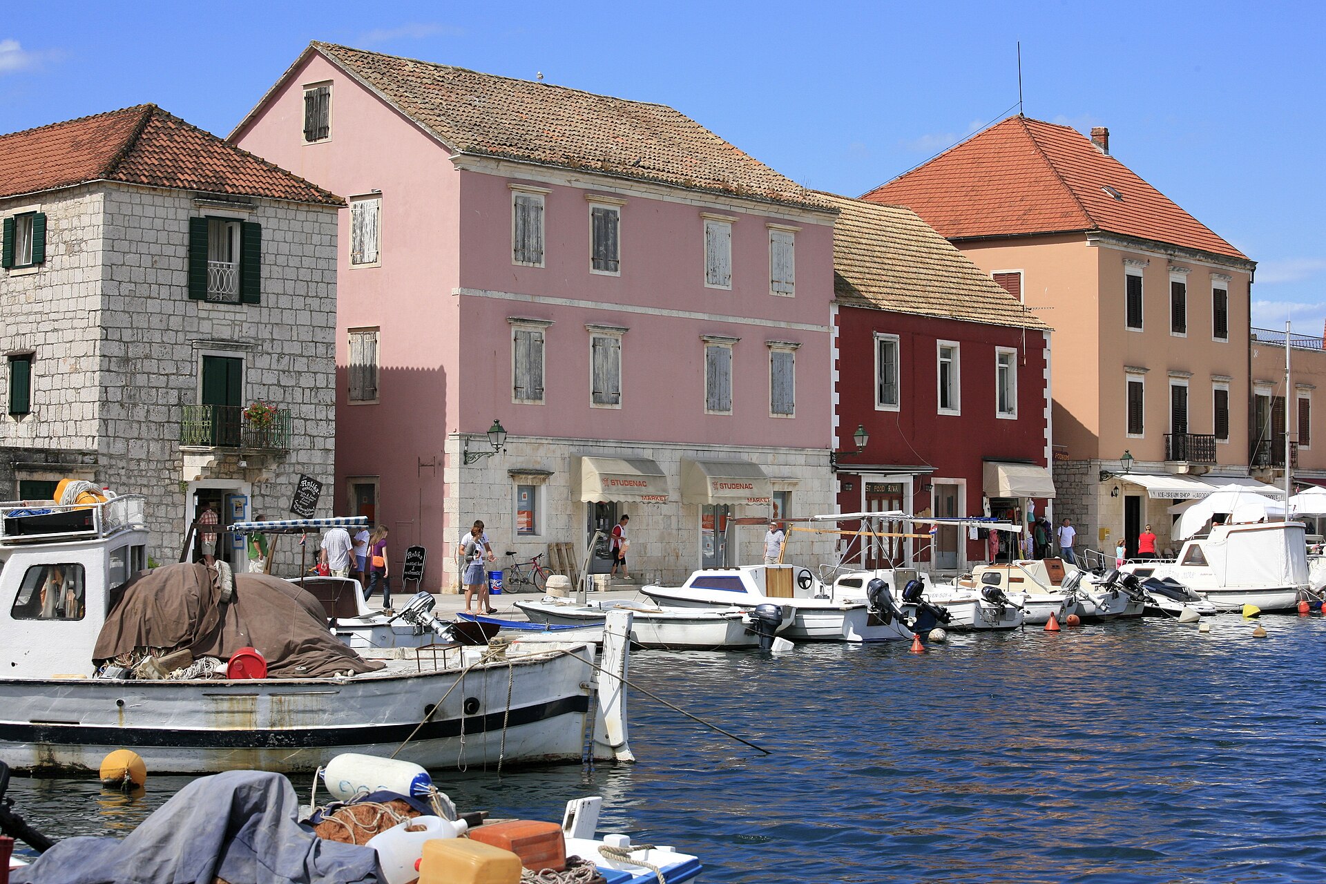 Pastel waterfront houses and moored boats in a harbour on Hvar island, Croatia