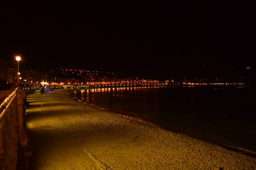 Vivid orange sunset over La Concha bay in San Sebastian Spain