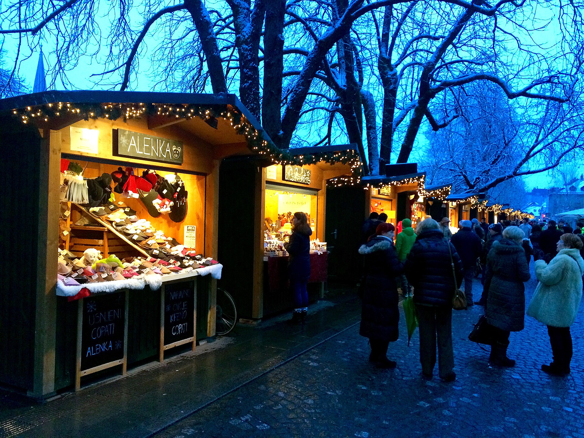 The Ljubljana Christmas market lit up along the river in December