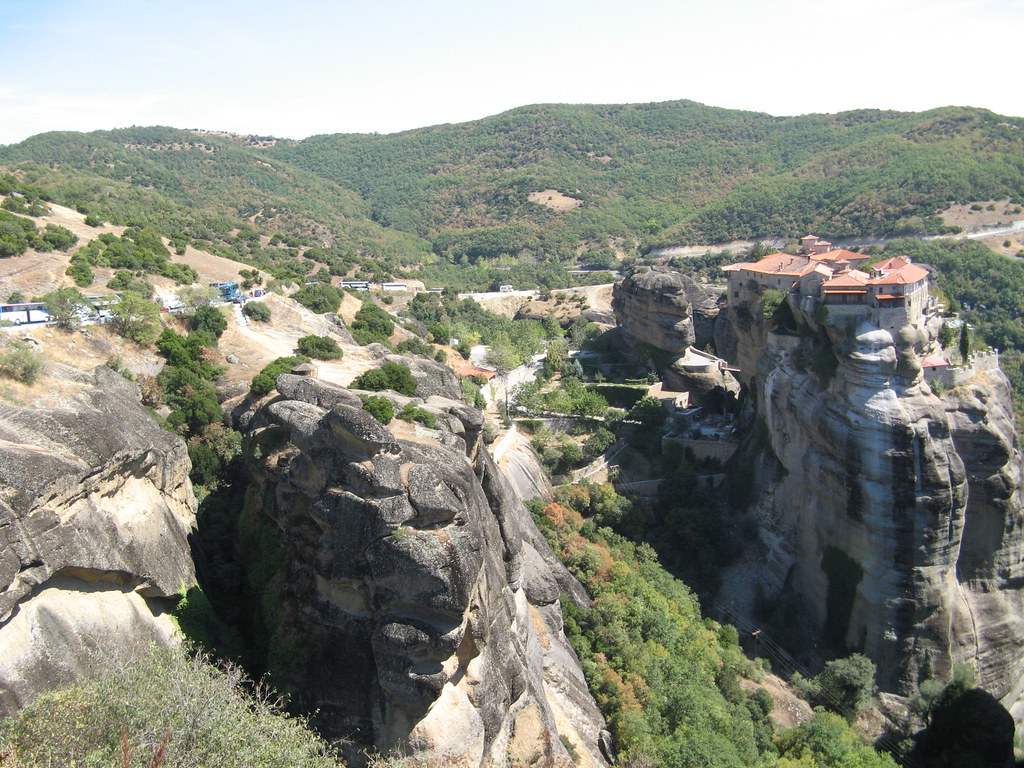 View across the Meteora rock formations with a monastery on the summit